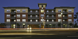 Peninsula Station affordable housing is a modern building at night