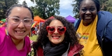 Supervisor Corzo is smiling next to two friends at the Pride Festival.