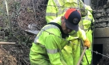 Crews repairing damaged culvert