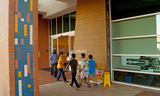 Group of children walk excitedly into the Foster City Library